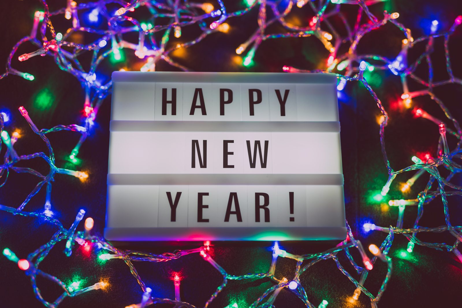 lightbox with Happy New Year message surrounded by colorful fairy lights